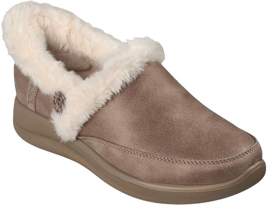 Bruine Skechers dames pantoffel met een zachte, crèmekleurige pluche voering en een subtiel logo-detail aan de zijkant.