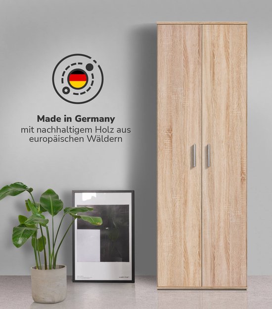 Hoge bruine kast met houten textuur, met 2 deuren, naast een plant en een ingelijste print.