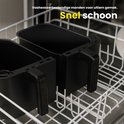 Twee zwarte manden van de dubbele heteluchtfriteuse staan in een vaatwasser.