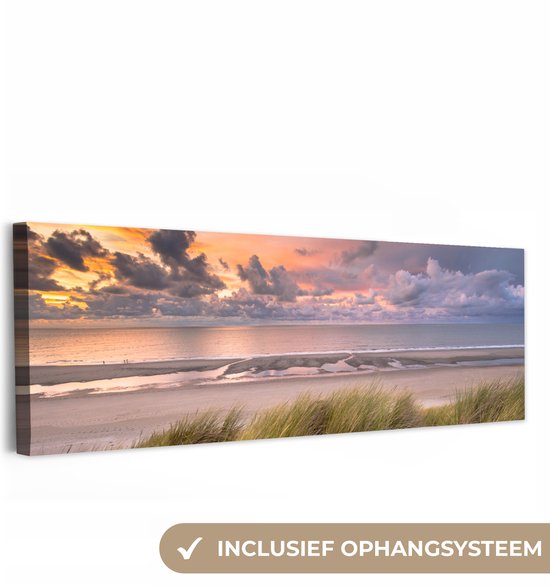 Toile représentant une plage au coucher du soleil avec de l'herbe de dune au premier plan, avec le texte 'Système de suspension inclus'.