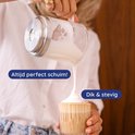 Close-up van melkopschuimer die dik, stevig schuim in een glas schenkt. Tekst "Altijd perfect schuim!", "Dik & stevig".