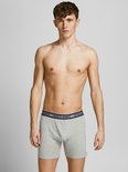 Man draagt een lichtgrijze Jack & Jones boxer met blauw logo-elastiek.