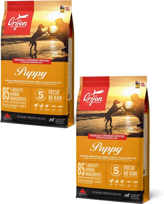 Orijen Puppy voerzakken met op de voorkant een zonsondergang op het strand met een puppy en een persoon.
