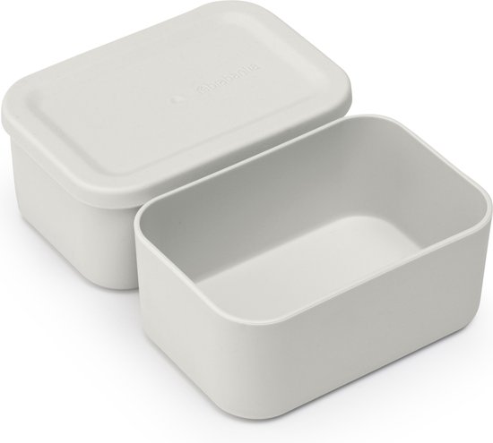Un petit compartiment gris vide, avec son couvercle à côté.
