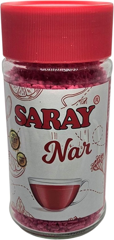 Thé instantané Saray Nar à la grenade dans un pot en verre avec un couvercle rouge. Le thé est de couleur rose/rouge.