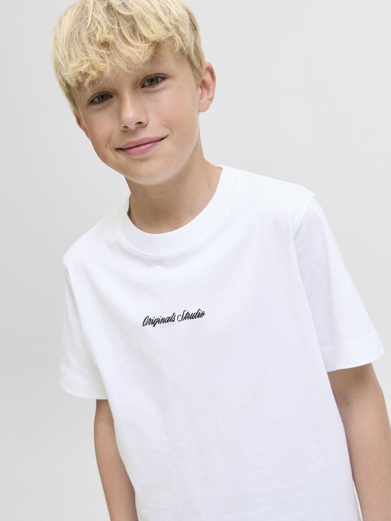 Jongen met blond haar draagt een wit T-shirt met "Originals Studio" tekst.