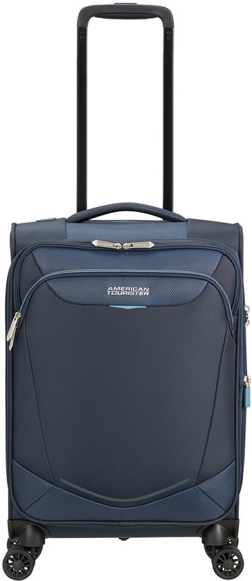 Donkerblauwe reiskoffer met vier wielen, uitschuifbaar handvat en American Tourister logo.