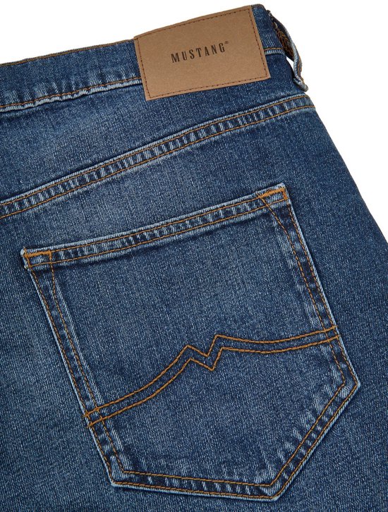 Achterkant van een blauwe jeans met het Mustang logo op een leren patch en oranje stiksels op de zak.