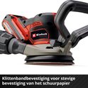 Close-up van een rode en zwarte schuurmachine met een grijze basis en een ronde schuurpad.