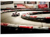 WallClassics - PVC Schuimplaat- Karter op Indoor Kartbaan - 75x50 cm Foto op PVC Schuimplaat