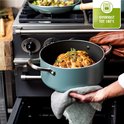 Lichtblauwe pan met een geroosterde bloemkool wordt uit een oven gehaald. De tekst 'Ovenvast tot 180°C' staat in de hoek.