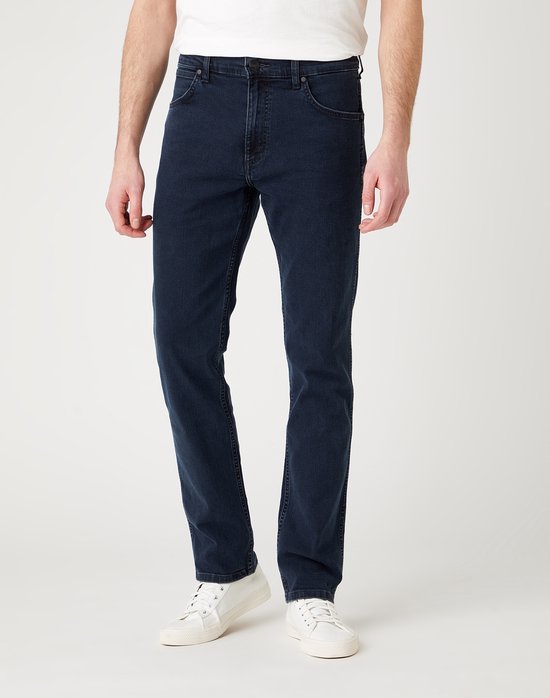 Man die een donkerblauwe Wrangler-spijkerbroek draagt, van voren gezien.