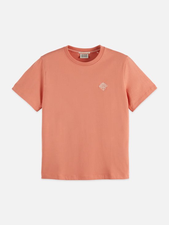T-shirt corail à manches courtes orné d'un motif graphique blanc brodé sur la poitrine.