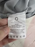 Kleine productielabel met wasinstructies voor het grijze Odoxia verzwaringskussen.