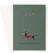 Hound & Herringbone - Carte de Noël de teckel noir - Carte de voeux festive de teckel noir et feu