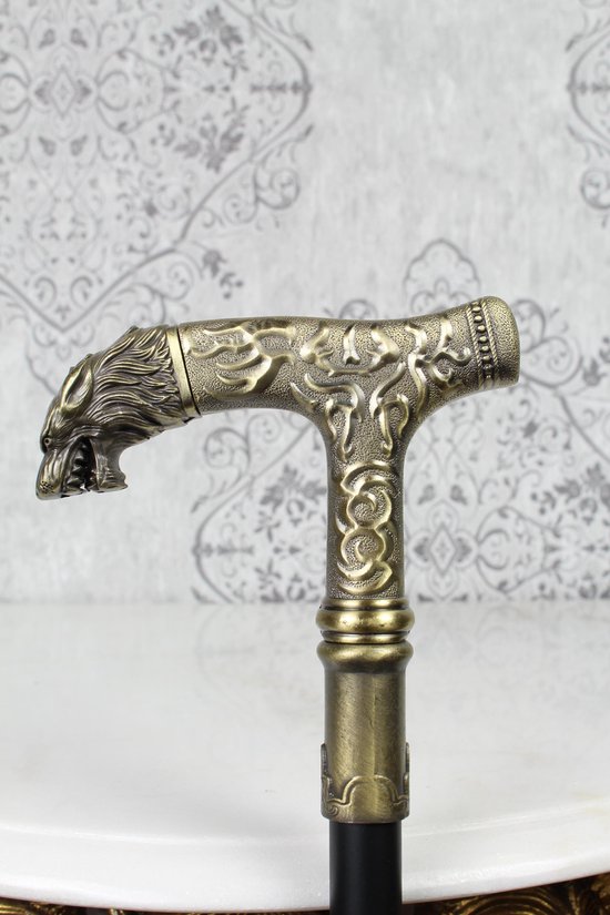 Gouden wandelstok handvat met een wolfskop en reliëfversieringen.