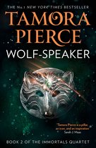 Boekomslag van Wolf-Speaker door Tamora Pierce met een zilveren wolvenmasker met een groene edelsteen op donkergroene achtergrond.