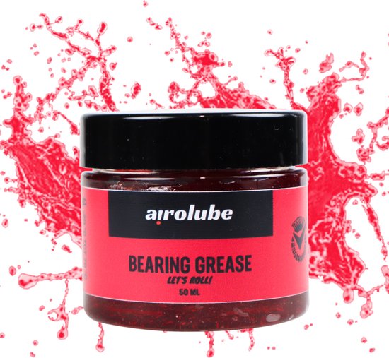 Potje zwart met rood label met witte tekst 'Airolube Bearing Grease'. Rood vloeistof spat op de achtergrond.