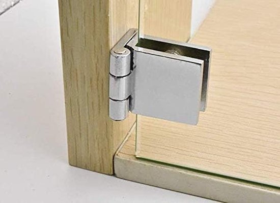 Glazen deurscharnier, zilverkleurig, gemonteerd op een houten kast en een glazen deur.