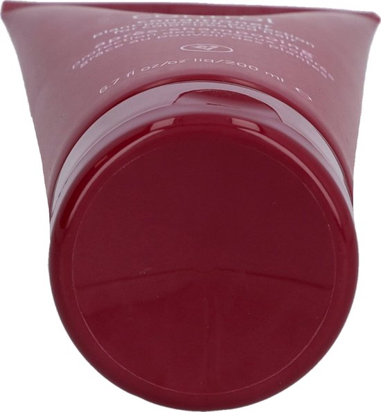 Sluiting en onderkant van een donkerrode Aveda Color Control conditioner tube.