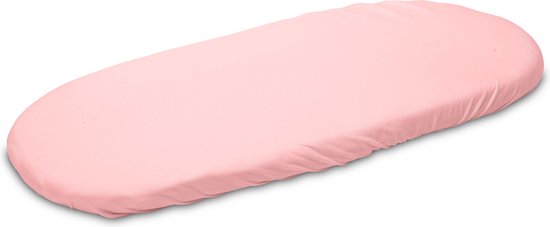 Roze jersey hoeslaken op een ovaal babymatras, vanuit een hoek.