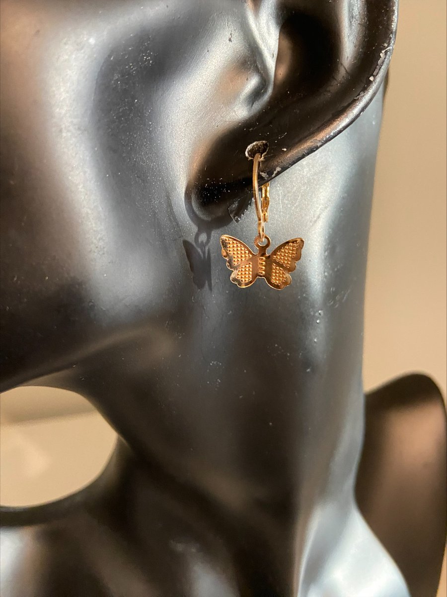 goudkleurig oorringetje met goudkleurige vlinder