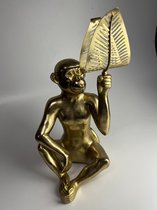 Grote metalen gouden aap met blad