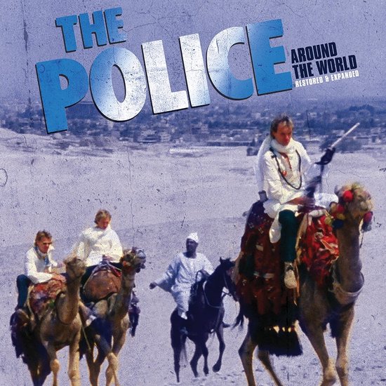 Albumhoes van The Police - Around The World. Bandleden rijden op kamelen in een woestijnlandschap.