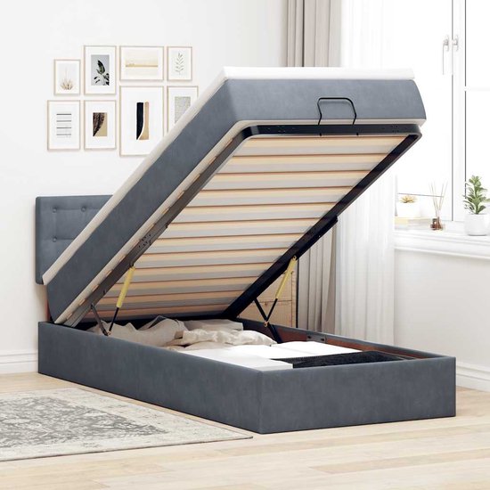 Donkergrijs bedframe met opbergruimte, openklapbare matras en gestoffeerd hoofdbord.