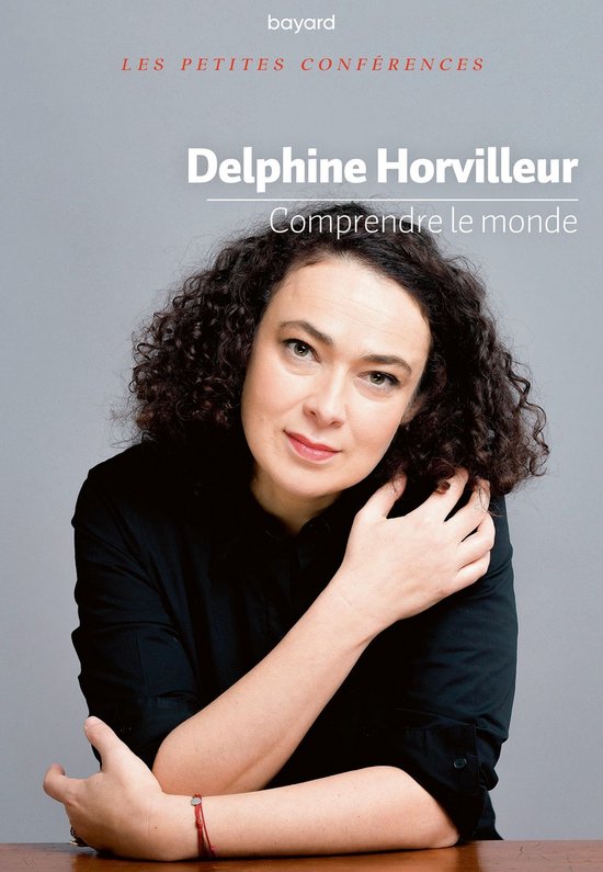 Portret van Delphine Horvilleur met krullend haar, gekleed in een zwarte blouse, met een rode armband om haar pols.