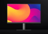 BenQ monitor met gele, oranje en paarse vloeiende abstracte vormen op het scherm. Zwarte achtergrond.