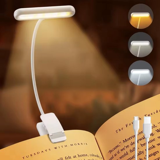 Witte leeslamp op een boek, verlichting in drie standen: warm, neutraal, koud.