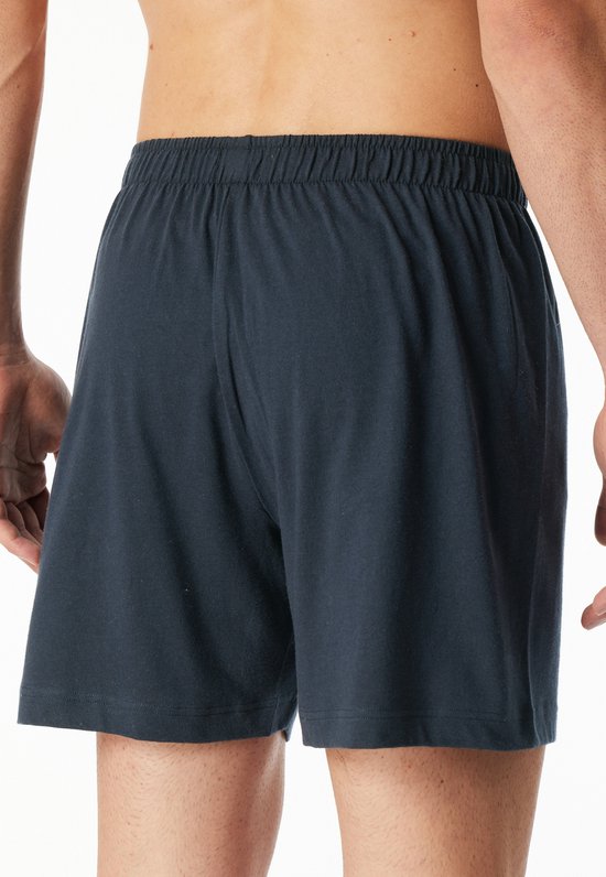 Donkerblauwe boxesshorts, achterkant op model, elastische tailleband.