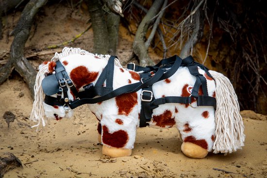 Wit pluche paardje met bruine vlekken en tuig. Wit paardenhaar op hoofd en staart.