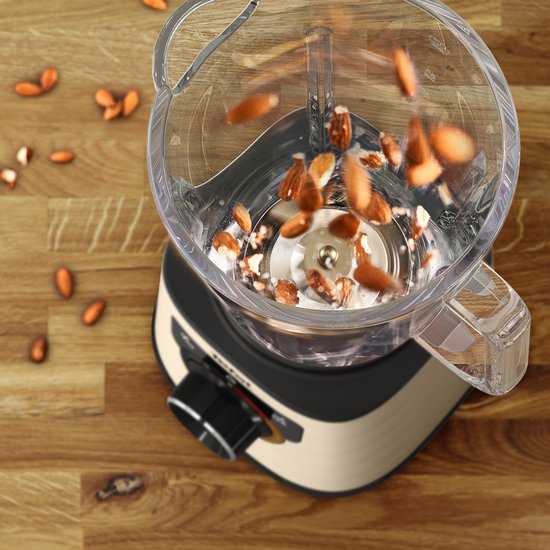 Gouden Tefal blender met vallende amandelen in de glazen kan.