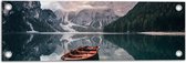Tuinposter – Houten Vissersboot op Meer in het Dal van Bergen op Koude Dag - 60x20 cm Foto op Tuinposter (wanddecoratie voor buiten en binnen)