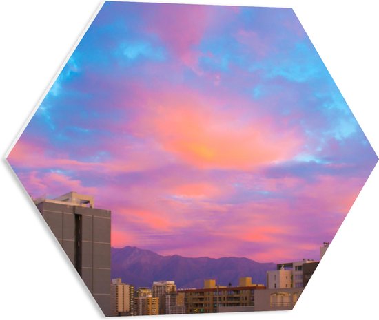 PVC Schuimplaat Hexagon - Felkleurige Lucht boven Gebouwen in het Blauw met Roze en Paars - 50x43.5 cm Foto op Hexagon (Met Ophangsysteem)