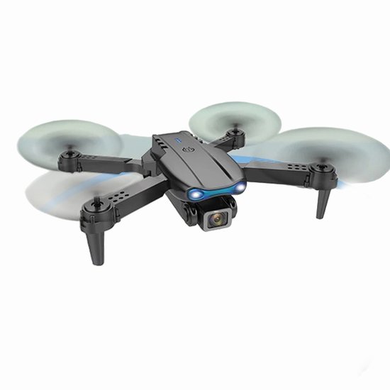 Grijze vouwbare drone met camera en draaiende propellers.