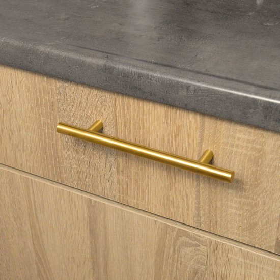 Goudkleurige, ronde RVS meubelgreep gemonteerd op een houten lade.
