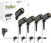 Set van vier zwarte Xelloo Jero grondspots met stekker en 12V-aansluiting, naast de verpakking.