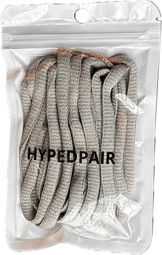 Lichtgrijze, ovale schoenveters verpakt in een doorzichtige plastic zak met een hangende opening. De tekst 'HYPEDPAIR' staat op de zak.