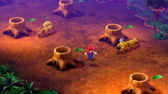 Mario staat in een bosrijke omgeving met boomstronken, omringd door gele rupsachtige wezens.