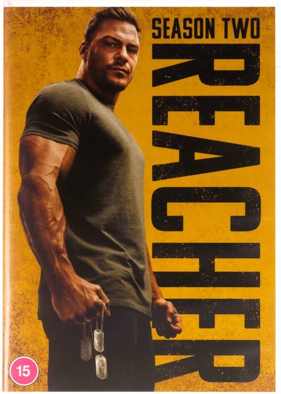 Couverture DVD Reacher saison 2 avec Alan Ritchson portant un t-shirt gris et un pantalon noir, tenant une chaîne avec des plaques d'identification.