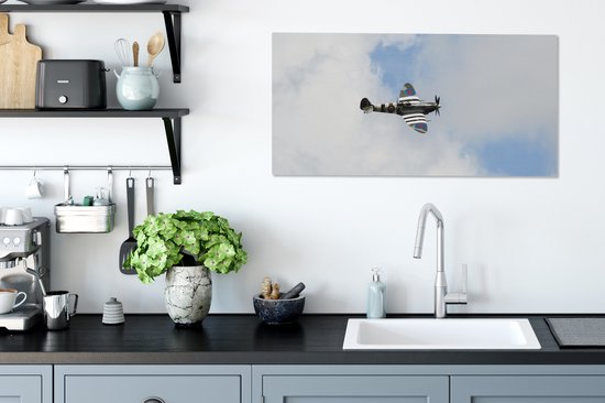 Tableau sur toile Avion Spitfire dans un ciel nuageux - 80x40 cm - Décoration murale