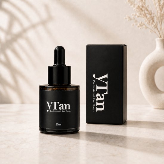 Flesje YTan Professional Tan Drops en bijpassend doosje op marmeren ondergrond.
