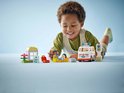 Kind speelt met LEGO Duplo ambulance, doktersfiguur, ziekenhuisje met bloemen en verkeerslicht.