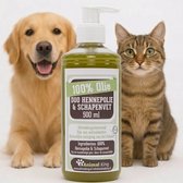 Donkere fles met groen etiket '100% Olie DUO HENNEPOLIE & SCHAPENVET 500ml'. Een lachende golden retriever links, een cyperse kat rechts.