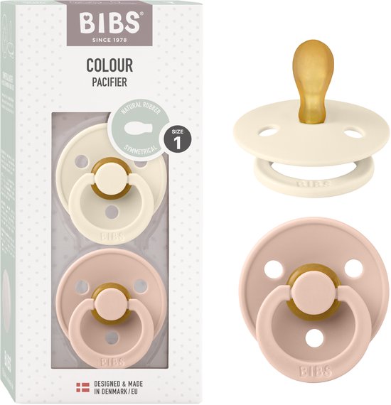 Emballage avec deux sucettes BIBS Colour, taille 1. Une sucette est crème, l'autre est rose blush. Avec tétine symétrique en caoutchouc naturel.
