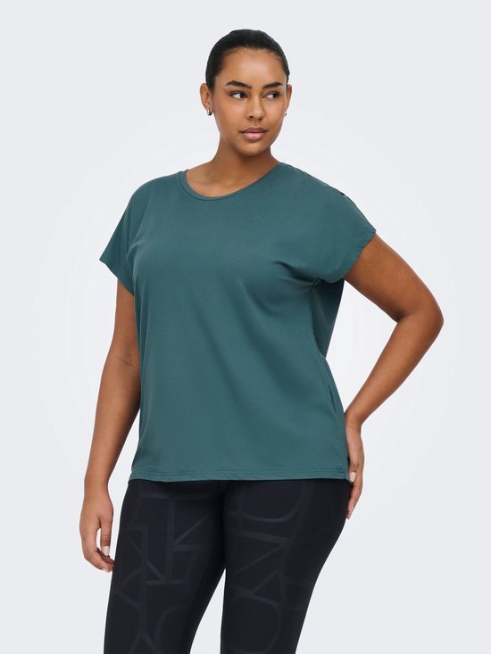 Model in een petrolkleurig sportshirt met korte mouwen en een zwarte legging met grafische print.