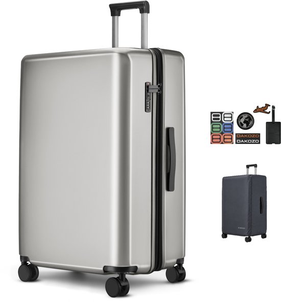 Valise DAKOZO argentée avec roues, poignée, serrure à combinaison TSA et divers autocollants. Housse de valise incluse.